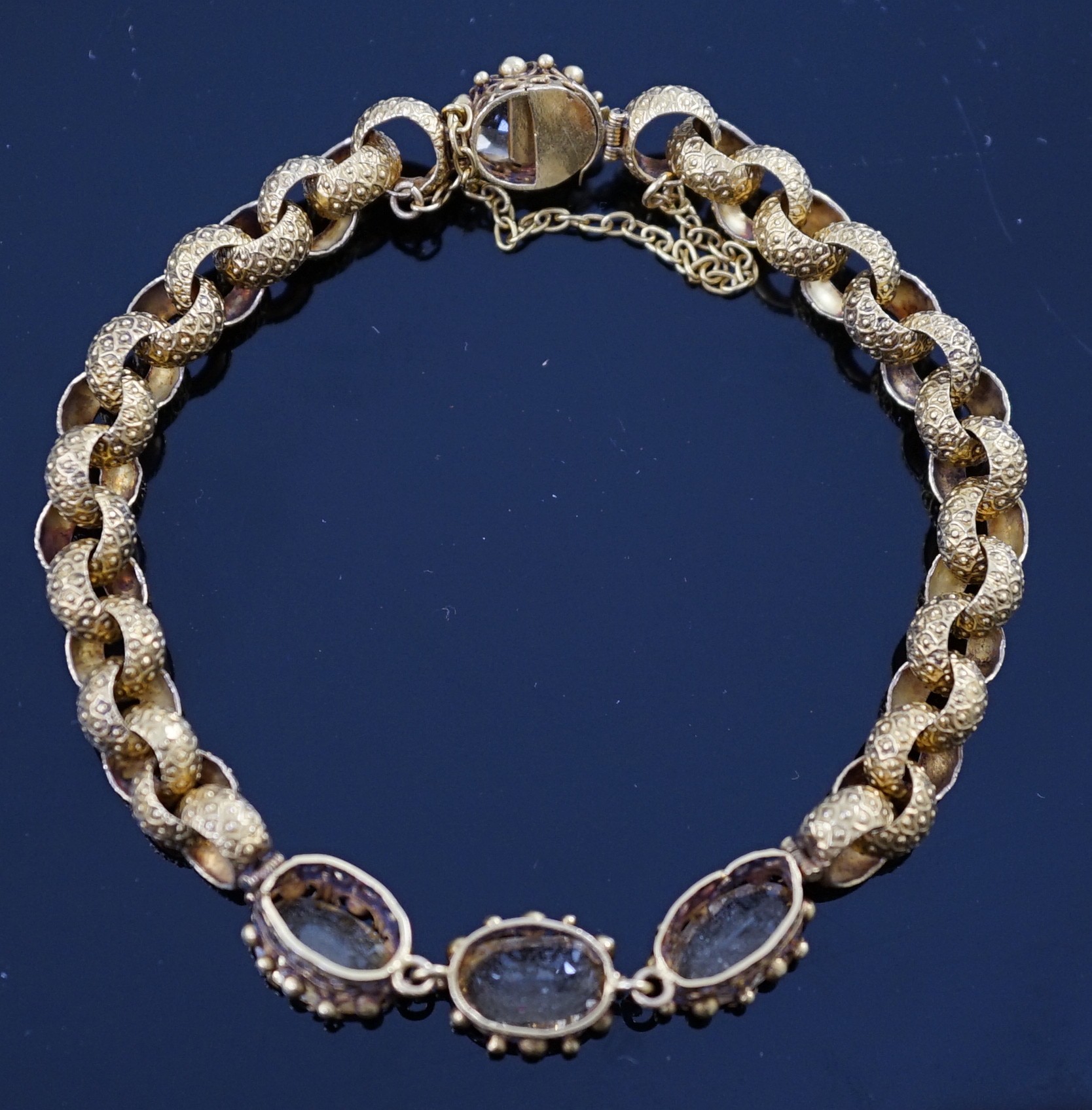 A 19th century cannetille work gold and four stone oval cut citrine set circular link bracelet